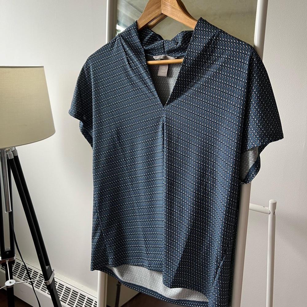 Navy and white collarless blouse.